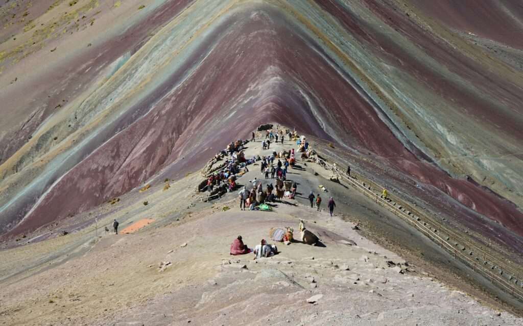 Hikers on the striped ridge of Vinicunca, Rainbow Mountain